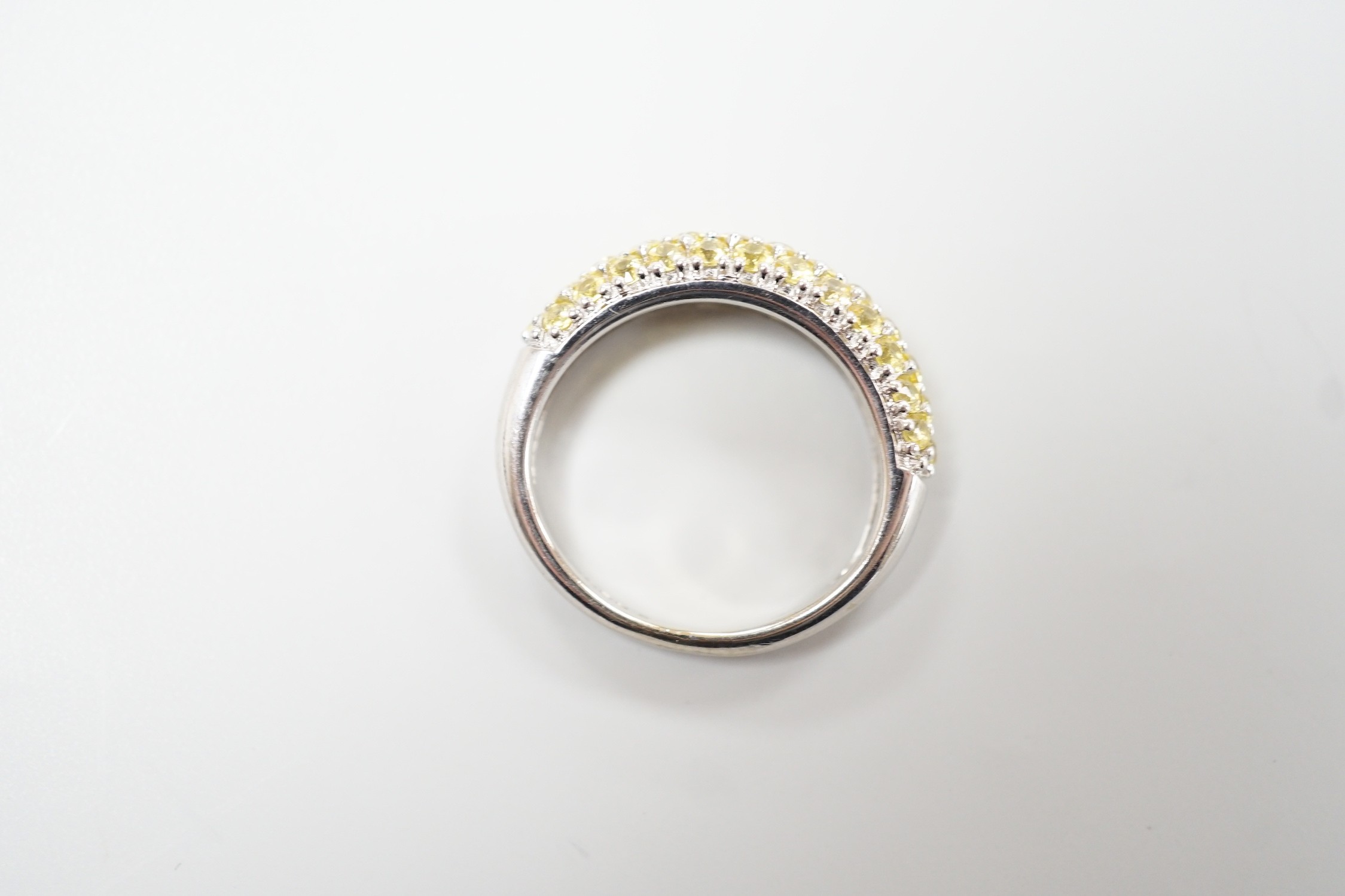 A modern 18ct white gold and yellow stone cluster set half hoop ring, size K, gross weight 4.2 grams.